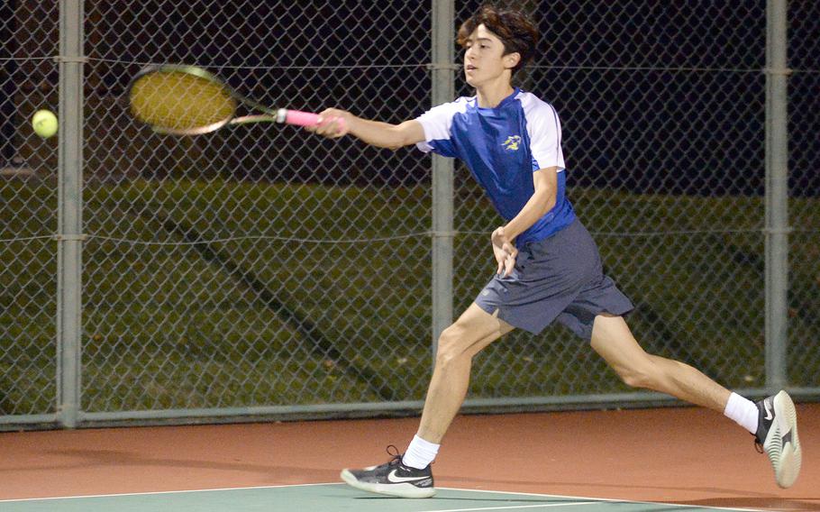 Yokota's Tommy Vogeley lunges to hit a forehand against Christian Academy Japan's Easton Lowther during Wednesday's Kanto Plain tennis matches. Lowther won 8-6.