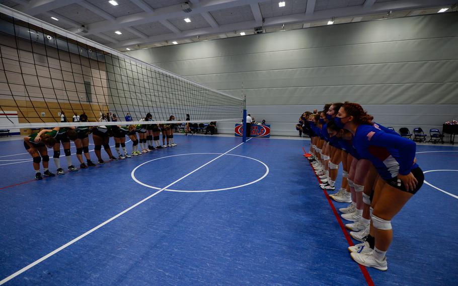 SHAPE Spartans, left, and Ramstein Royals bow in a display of sportsmanship during the DODEA-Europe Division I Volleyball Tournament  at Ramstein Air Base, Germany, Oct. 29, 2021. Athletes and spectators alike observed strict public health measures, to include mask wear on the court.