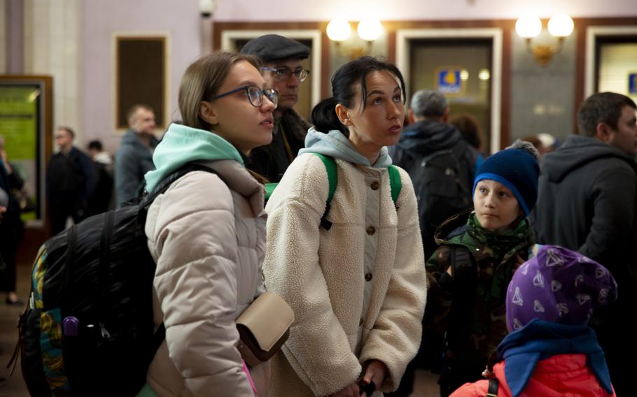 Tanya Morozova, 40, and three of her children wait to board Train 750L in Lviv, Ukraine.