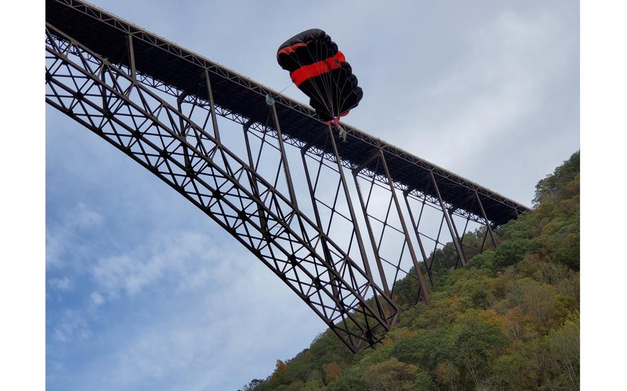A BASE jumper takes flight at the New River Gorge Bridge in West Virginia. BASE is an acronym for building, antenna, span and earth, the fixed objects from which participants parachute.