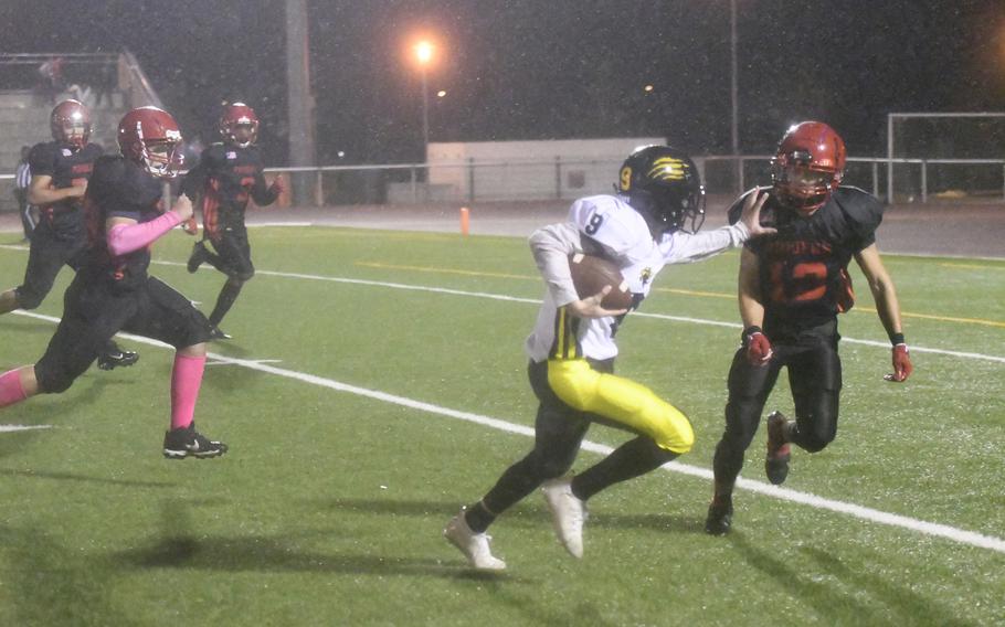 Stuttgart quarterback Caiden Ray stiff-arms Kaiserslautern's Joseph Rodriguez-Martinez as he runs into the endzone to score one of his two running touchdowns during the Panthers' 53-12 win in Kaiserslautern, Friday, Oct. 17, 2021.