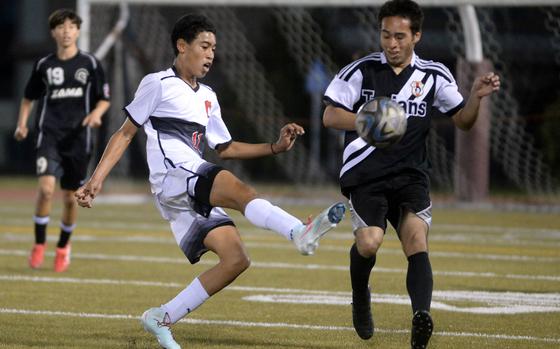 Kinig's Danial Leak boots the ball against Zama's Isaiah Segarra.