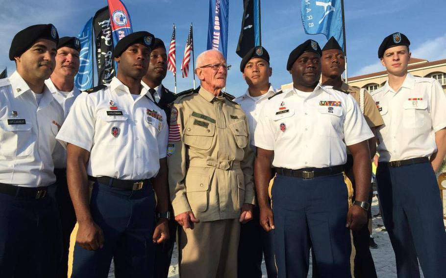 Soldiers of Alpha Company posing with World War II veteran Tom Rice, center,  in 2015.