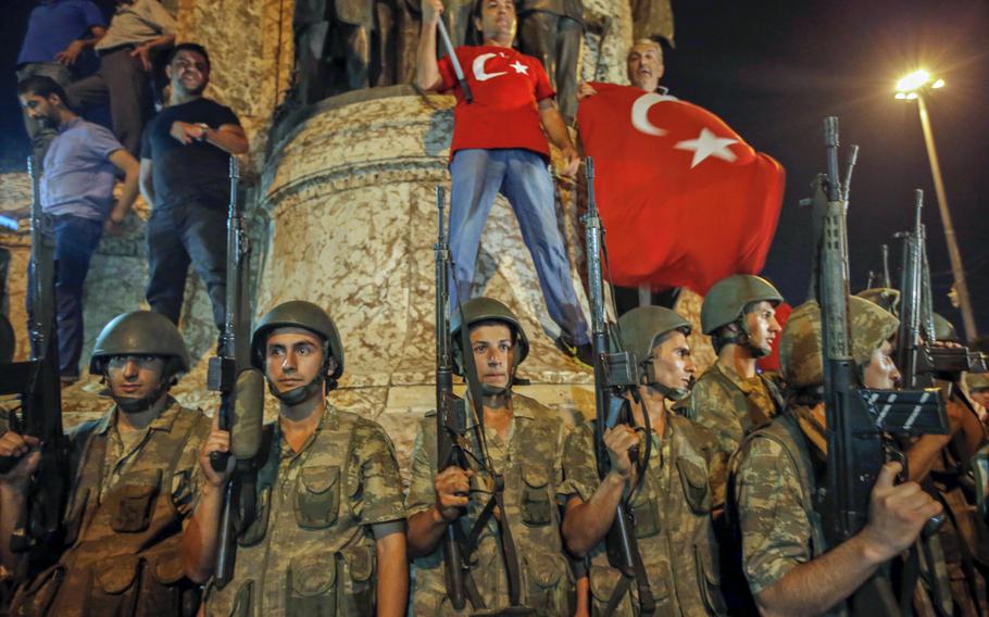 Turkish soldiers secure the area as supporters of Turkey's President Recep Tayyip Erdogan protest in Istanbul's Taksim square, early Saturday, July 16, 2016.