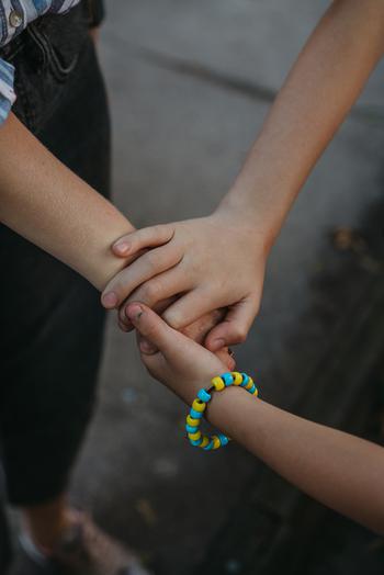 Kira wears a bracelet with the colors of the Ukrainian flag that she made this summer at St. Nicholas Cathedral School. 