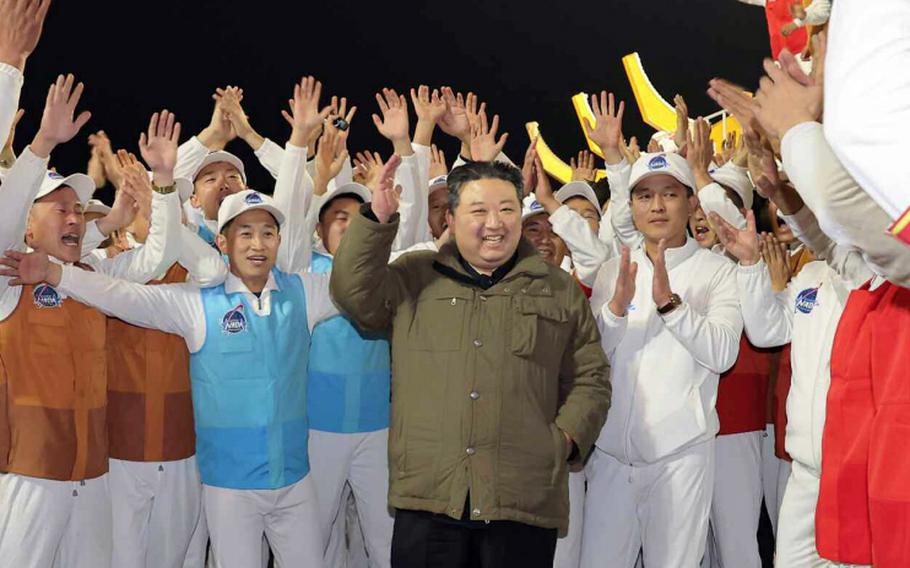 In this image released by the state-run Korean Central News Agency, North Korean leader Kim Jong Un celebrates the country’s launch of a rocket with a spy satellite aboard on Nov. 22.