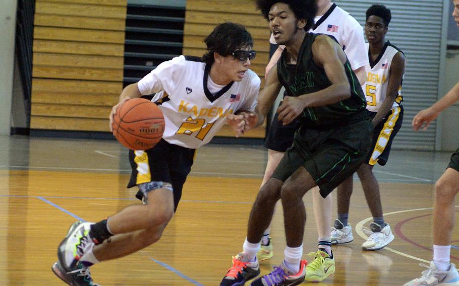 Kadena's Angel Torrado drives on Kubasaki's Zyiere Paul during Sunday's third-place game, won by Kubasaki 63-56.