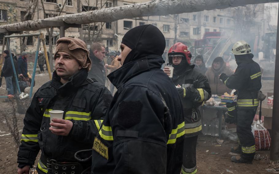 Rescuers rest as their colleagues continue the search. 