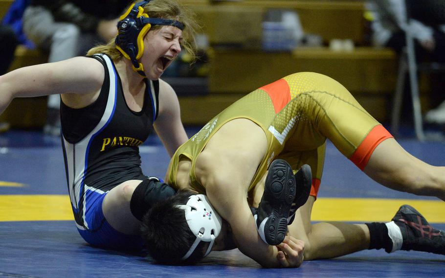 Yokota's Zaylee Gubler yells as she gets caught in a leg lace by St. Mary's Luke Shane at 122 pounds during Wednesday's Kanto Plain wrestling dual meet. Shane won by technical fall 12-1 in 3 minutes, 19 seconds and the Titans won the meet 46-5.