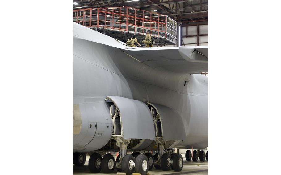 United States Air Reserve Master Sgt. Anthony Botass of Tolland, and Tech Sgt. Joshua Newman of Enfield, work on the aileron of a C-5M Super Galaxy in a maintenance hangar at Westover Air Reserve Base in Chicopee, Mass.  
