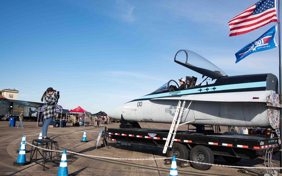 People pose for photos at the “Top Gun Cockpit Experience” static display during the 2024 Beyond the Horizon Air and Space Show at Maxwell Air Force Base, Ala., Saturday, April 6, 2024. 