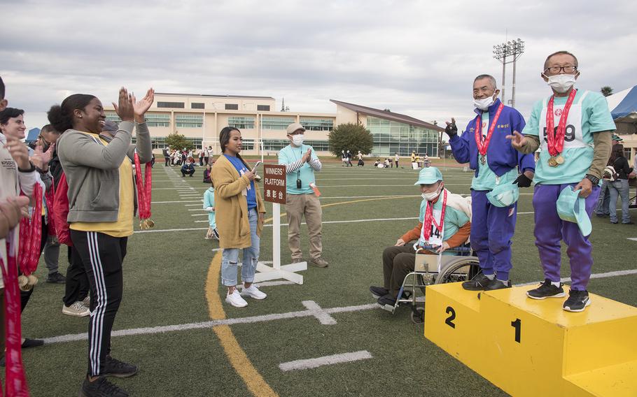 Air Force Staff Sgt. Bevonia Williams, 28, of Harlem, N.Y., cheers on the winner athletes during the medal ceremony during the Kanto Plains Special Olympics at Yokota Air Base, Japan, on Nov. 5, 2022. 