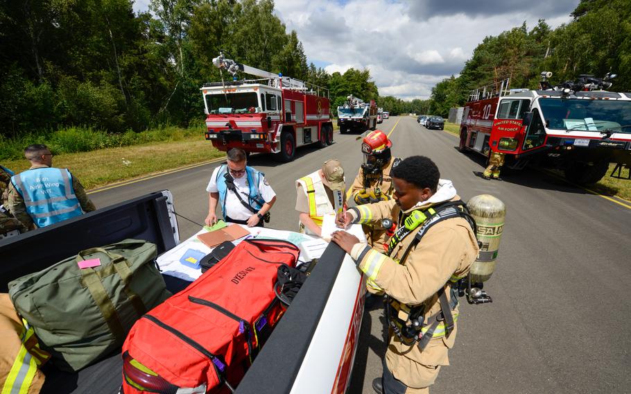 Firefighters with the 86th Civil Engineer Group stand up a mobile incident command during a simulated aircraft crash scenario at Germany, July 26, 2022. The response was part of Operation Varsity, an exercise testing the 86th Airlift Wing’s ability to respond to major emergencies including the blast of sirens signaling a fictional tornado and a simulated aircraft crash.