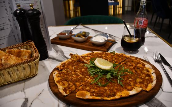 Lahmacun from Turkoman restaurant in Newmarket, England, is served with an assortment of dips, May 9, 2023. Lahmacun is Turkish flatbread seasoned with lamb, onions, red peppers and parsley.
