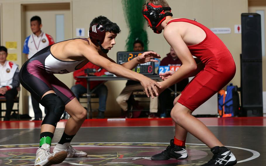 Matthew C. Perry's Sebastian Campbell squares off with E.J. King's Jack Snyder at 115 pounds during Saturday's DODEA-Japan wrestling dual meet. Campbell won by pin and the Samurai won the dual meet 37-21.