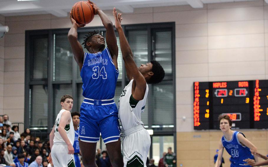 Rota’s Brian Leiba attempts a shot over Naples’ Chris White in the Division II championship game at the DODEA-Europe basketball finals in Ramstein, Germany, Feb. 18, 2023. Naples beat Rota 46-25 to take the division title.