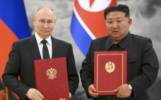 Russian President Vladimir Putin, left, and North Korea’s leader Kim Jong Un pose for a photo.