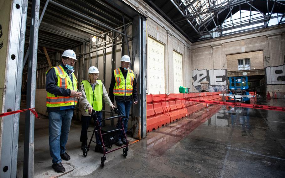 Michigan Central construction manager Richard Bardelli, left, and project manager Gary Marshall, right, guide George England for a tour inside Michigan Central Station in Detroit on Sept. 25, 2021.