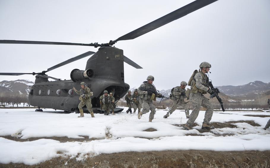 U.S. and Afghan troops file out of a helicopter at the beginning of a mission in Wardak province. They were responding to recent reports of Taliban intimidation and kidnappings.