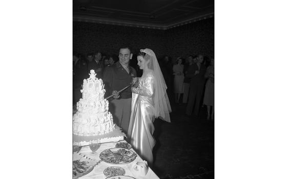 Schloss Hotel, Heidelberg, Germany, Jan. 8, 1949: No doubt several proposals are happening across U.S. bases this Valentine's Day, leading many military couples down the aisle. We're not sure who proposed to whom, or when, but Stars and Stripes was there when Miss Barbara Donze Kiechel, daughter of Lt. Col. D.F. Kiechel, said yes to Lt. Col. Edward McKaba, executive officer, Rhine-Main Air Base in 1949. The bride wore white satin, carried a bouquet of white carnations, and there was this amazing cake!

Looking for Stars and Stripes’ historic coverage? Subscribe to Stars and Stripes’ historic newspaper archive! We have digitized our 1948-1999 European and Pacific editions, as well as several of our WWII editions and made them available online through https://starsandstripes.newspaperarchive.com/

META TAGS: Wedding; ceremony; military life; military community; love; way of life; bride; groom; cake; tradition; 