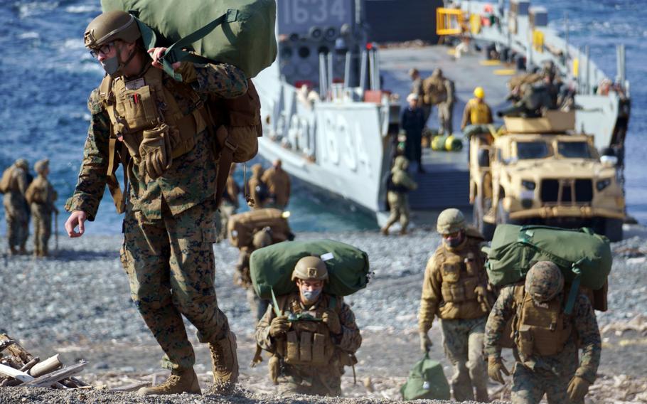 Members of the 31st Marine Expeditionary Unit come ashore at the Numazu Beach Training Area, Japan, during training with the Japan Ground Self-Defense Force, March 9, 2022. 