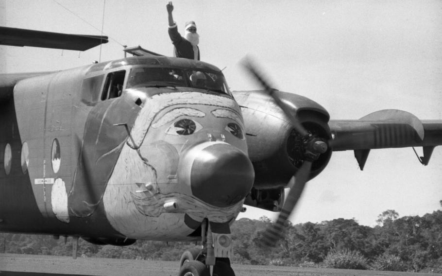 The “Santabou,” actually an Air Force C7 “Caribou,” serves as Santa’s sleigh as the Old Man makes his appearance at Nahon Cho, Vietnam, Dec. 21, 1968. Santa Claus waves from the cockpit as his “sled” lands at Nahon Cho, home of Detachment 35, “B” Company, 5th Special Forces Group, 80 miles northeast of Saigon. The Air Force lent Santa six C7 Caribou cargo planes for his deliveries in Vietnam. The planes came with the good wishes of the men of the 483rd Tactical Airlift Wing headquartered at Cam Ranh Bay. The airmen even decorated the planes, putting a large painting of Santa on each of their noses and renamed the planes “Santabous.” The planes enabled Santa to visit some 50 isolated outposts, from Dec. 24 until late in the afternoon Christmas day.