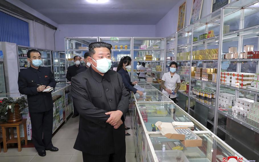 In this photo provided by the North Korean government, North Korean leader Kim Jong Un, center, visits a pharmacy in Pyongyang, North Korea on May 15, 2022. Independent journalists were not given access to cover the event depicted in this image distributed by the North Korean government. The content of this image is as provided and cannot be independently verified. Korean language watermark on image as provided by source reads: “KCNA” which is the abbreviation for Korean Central News Agency. 