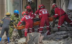 Rescuers recover a body at the site of Friday's deadly explosion that destroyed the five-star Hotel Saratoga, in Havana, Cuba, Saturday, May 7, 2022. (AP Photo/Ramon Espinosa)