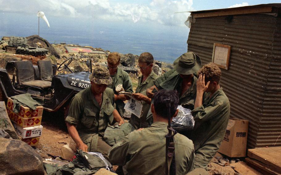 A soldier checks out an issue of the Pacific Stars and Stripes