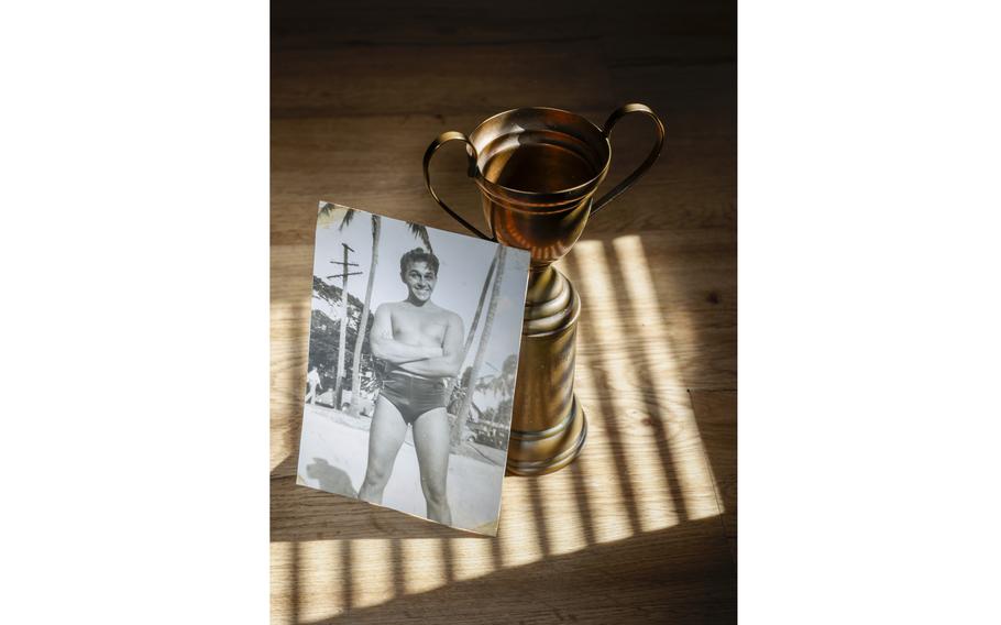 Martin Ecenia is seen in a photo from 1941 next to a dance competition trophy that he had won. 