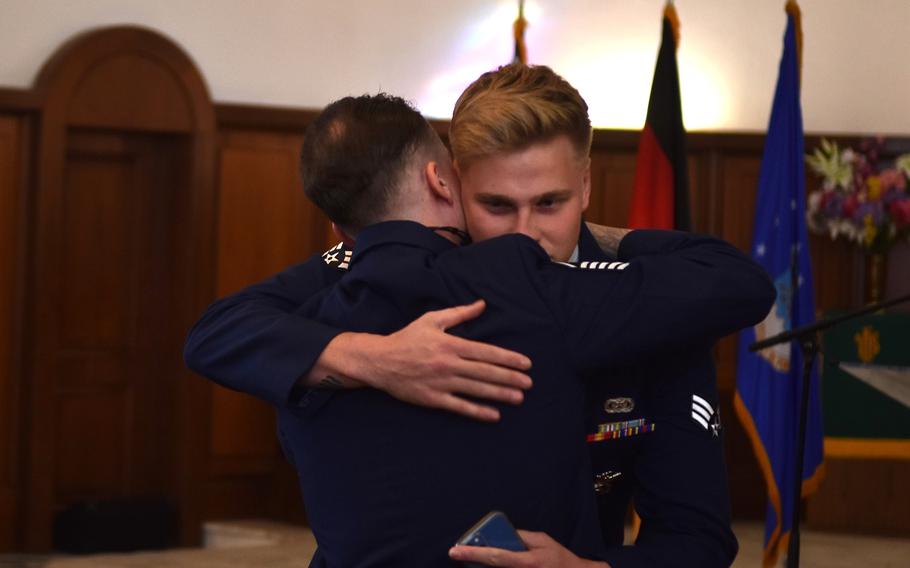 Senior Airman Mathew Sayer receives a hug during a memorial service for his friend and fellow security forces member Senior Airman Christopher Rocha. Rocha, part of the 569th U.S. Forces Police Squadron died in a military hospital in Maryland after a serious car crash near Ramstein Air Base, Germany, in August.