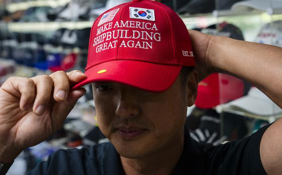 A South Korean man wears a red hat with the message, “Make America Shipbuilding Great Again.”