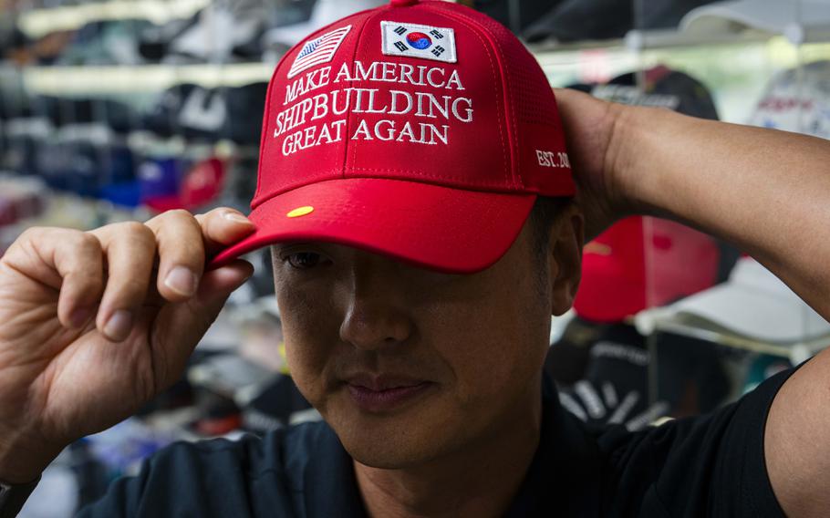 A South Korean man wears a red hat with the message, “Make America Shipbuilding Great Again.”