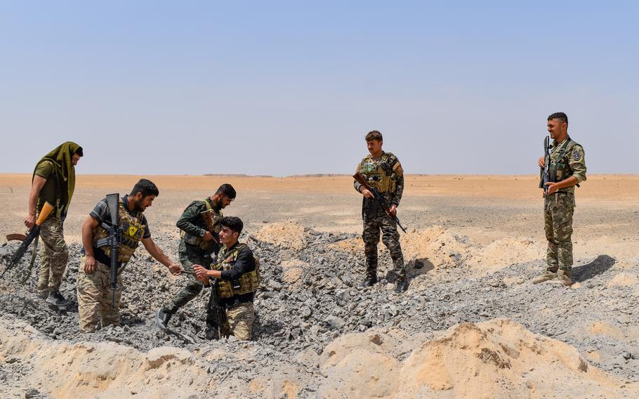Syrian Democratic Force soldiers conduct a patrol during a joint operation with U.S. Army soldiers in Syria on May 8, 2021.