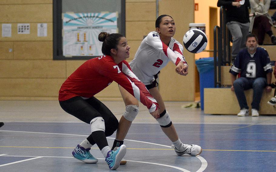 Kaiserslautern's Marisa Branch, left, and Kez Kai go to hit the ball during a Division I semifinal against Wiesbaden at the DODEA European volleyball championships on Oct. 27, 2023, at Ramstein High School on Ramstein Air Base, Germany.