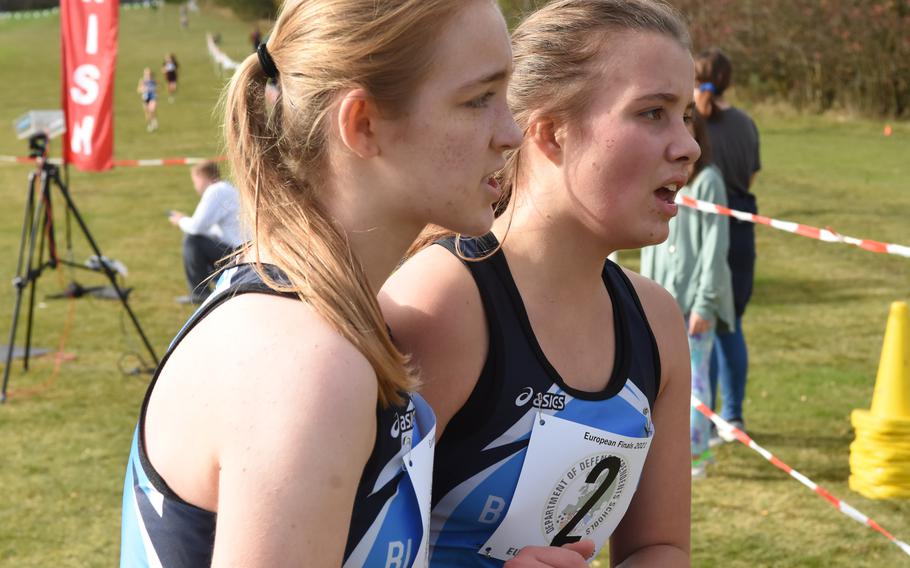 Black Forest Academy’s Bethany Hicks, left, and Elmi-Gret Van Westhuizen hold onto each other after finishing third and fourth, respectively, in the girls’ small schools division race at the DODEA-Europe cross country championships in Baumholder, Germany, on Saturday, Oct. 23, 2021.