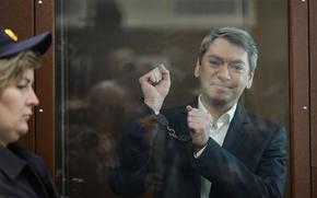 Grigory Melkonyants, co-chair of Russia's leading independent election monitoring group Golos looks at the media standing in a cage in a courtroom prior to a hearing in Basmanny district court in Moscow, Russia, Wednesday, May 14, 2025. (AP Photo/Alexander Zemlianichenko)