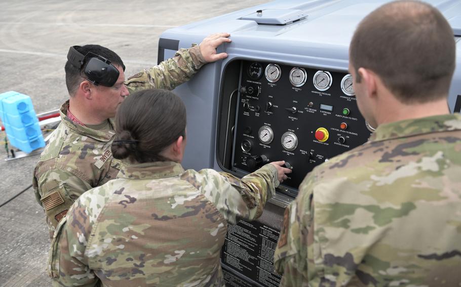 U.S. Air Force Tech Sgt. David Snyder, left, an air crew egress systems specialist, Tech Sgt. Rebecca Mertes and Master Sgt. William McNierney, tactical aircraft maintenance specialists, all with the Wisconsin Air National Guard’s 115th Fighter Wing, prepare to inflate an aircraft tire during a Weapons System Evaluation Program exercise Feb. 15, 2024, at Tyndall Air Force Base, Fla. 