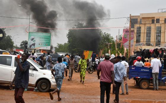 A general view of billowing smoke as supporters of the Nigerien defense and security forces attack the headquarters of the Nigerien Party for Democracy and Socialism (PNDS), the party of overthrown President Mohamed Bazoum, in Niamey on July 27, 2023. The head of Niger's armed forces said he endorsed a declaration by troops who overnight announced they had taken power after detaining the country's elected president, Mohamed Bazoum. "The military command of the Nigerien armed forces has decided to subscribe to the declaration by the defense and security forces... in order to avoid a deadly confrontation between the various forces," said a statement signed by armed forces chief General Abdou Sidikou Issa. (-/AFP via Getty Images/TNS)