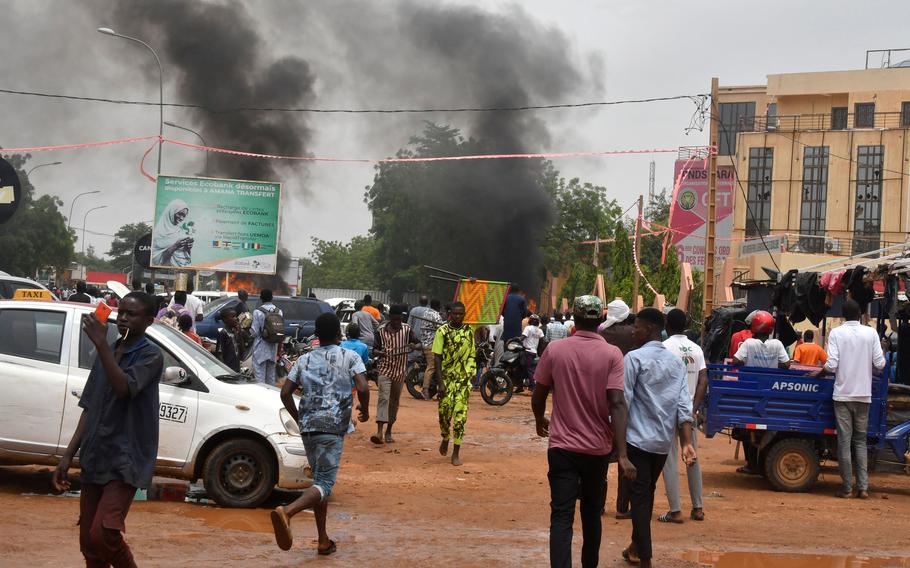 A general view of billowing smoke as supporters of the Nigerien defense and security forces attack the headquarters of the Nigerien Party for Democracy and Socialism (PNDS), the party of overthrown President Mohamed Bazoum, in Niamey on July 27, 2023. 