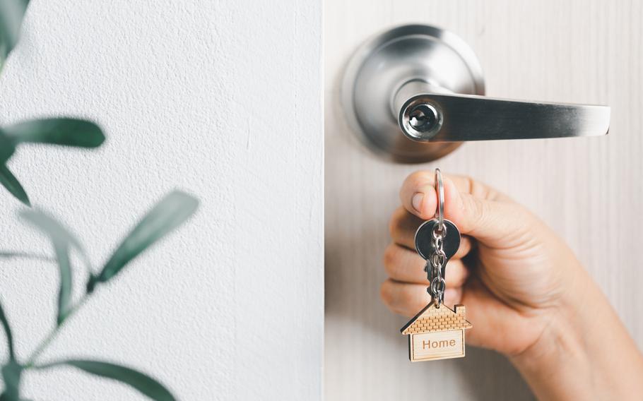 House model and key in house door.