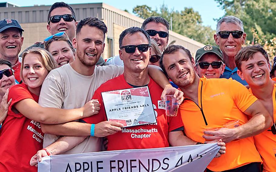 Steve Kowalski, center, who has ALS, poses with friends and family who participated in the 2018 Ride to Defeat ALS in Massachusetts.