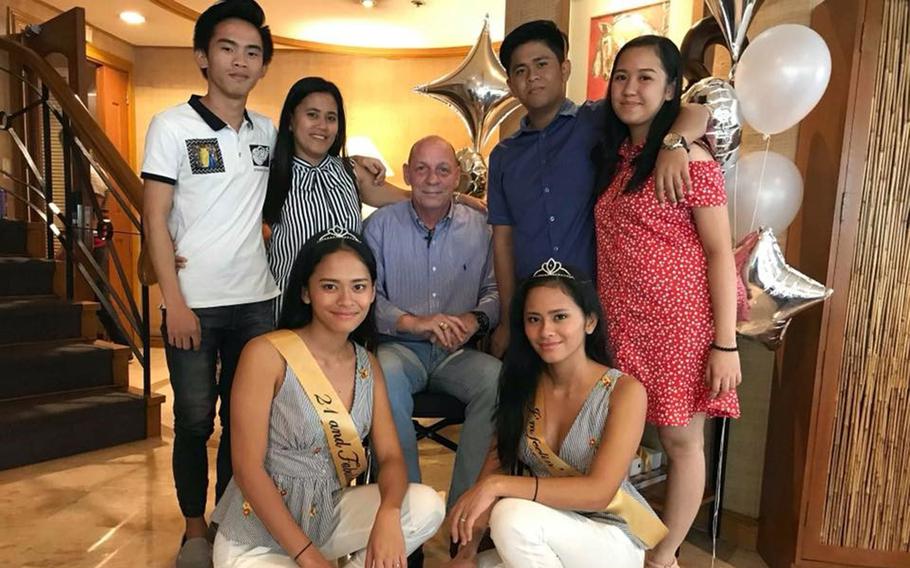 Army veteran Kevin Baltzley poses with family members, including his wife and stepchildren, in this undated photo taken in the Philippines.