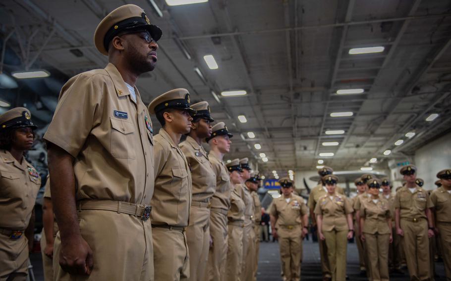 Chiefs attend a Chief Petty Officer Birthday observance in the hangar bay of the Nimitz-class aircraft carrier USS Harry S. Truman (CVN 75), on March 31, 2022. 