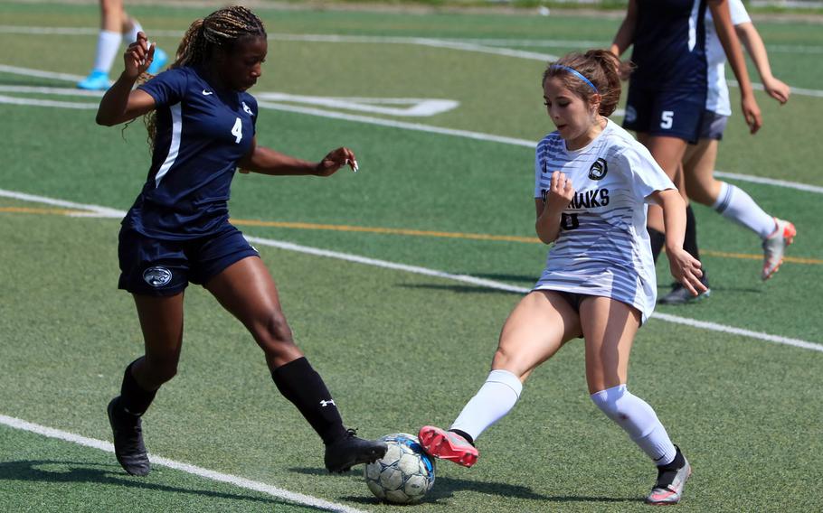 Osan's Tatiana Lunn and Humphreys' Elyanna Koch tangle for the ball during Saturday's DODEA-Korea girls soccer match. The Blackhawks won 6-2.