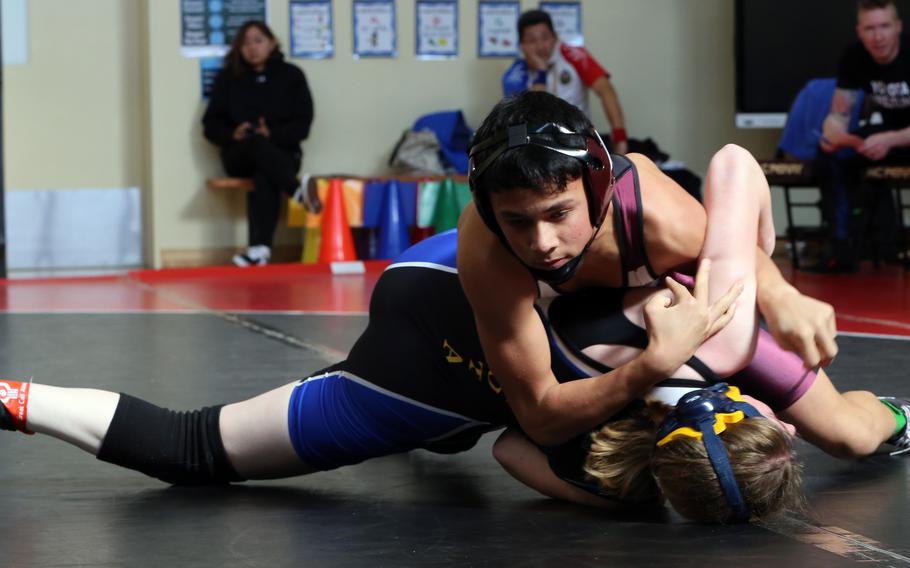 Matthew C. Perry's Gregory Campbell pins Yokota's Zaylee Gulbler at 122 pounds during Saturday's DODEA-Japan wrestling dual meet. The Samurai won the meet 39-21.