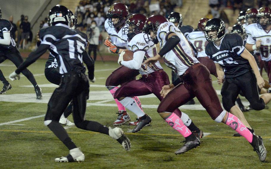 Matthew C. Perry running back Denzel Gray gets an escort upfield.