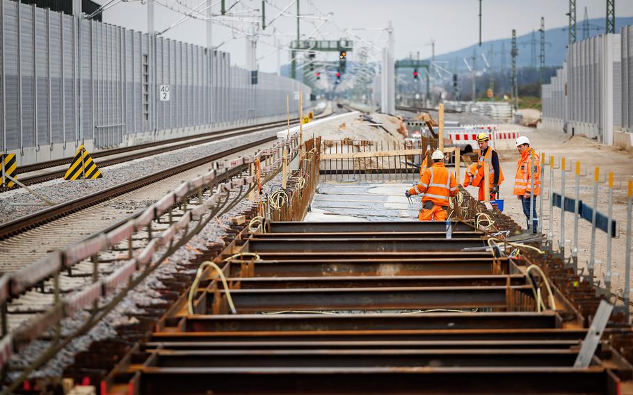 Construction laborers work on a railroad.