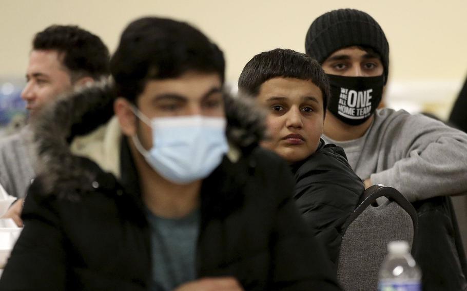 Afghanistan refugees gather for lunch following prayers with the Muslim community at the Mecca Center in Willowbrook, Ill., on Feb. 11, 2022. Chicago Tribune/TNS