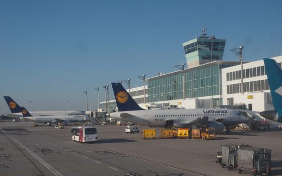 Planes are parked outside of a airport control center.